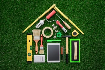 Top down view of a yard with multiple household items positioned to form a house